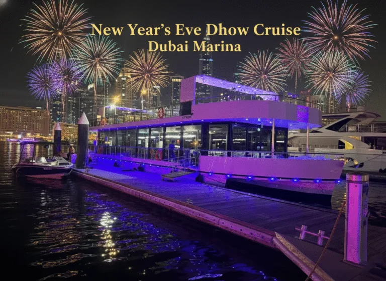 Cruise vessel lit up for New Year's Eve at its Dubai Marina berth with fireworks overhead