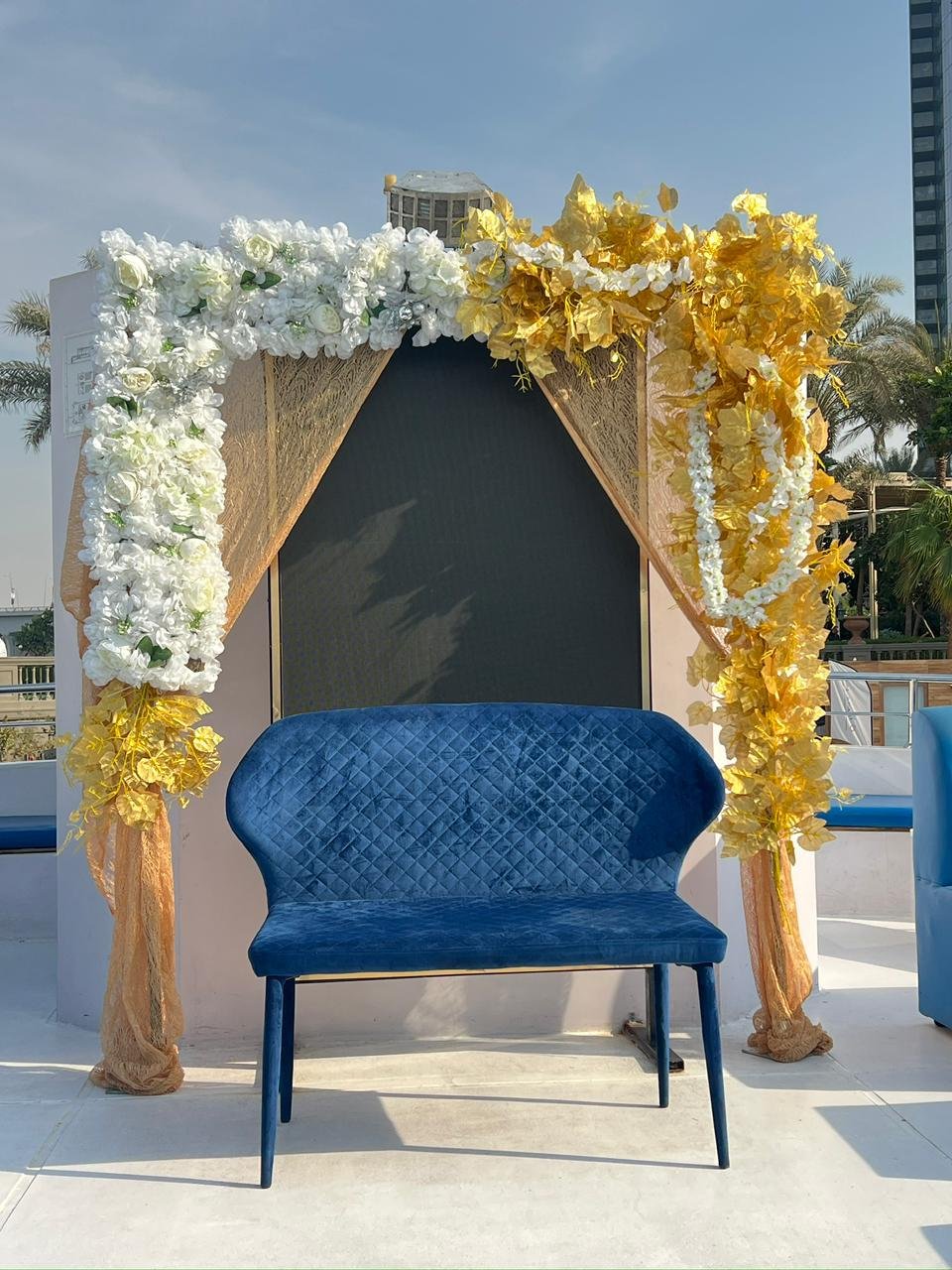 Birthday celebration table with gold decorations on a dhow cruise with Dubai skyline at night